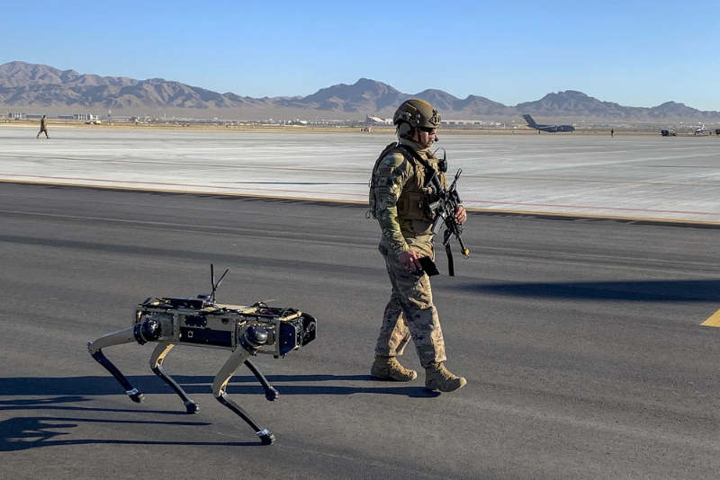 a military officer with an automate shooting robot | advanced weapon systems