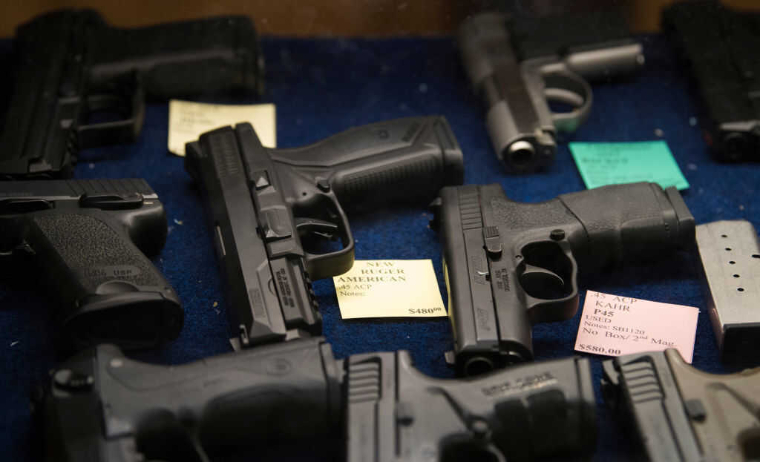 Guns placed in a row | firearms